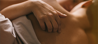 A-womans-hand-rubs-against-partners-back