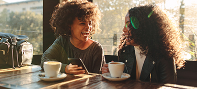 Two-women-laugh-over-coffee