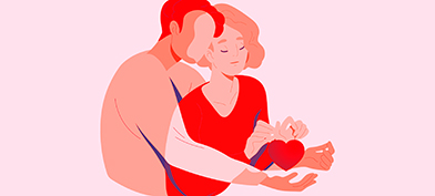 A man holds a woman from behind with a heart held in her hands.