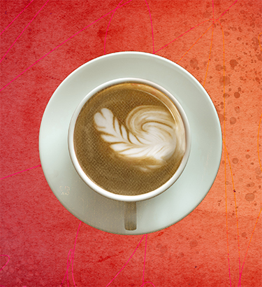 Latte art in a cup of coffee slightly depicts an erect penis. 