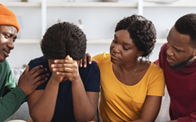 three-people-supporting-surrounding-one-person-in-crisis