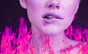 A woman bites her lower lip as pink and coral flames surround her shoulders.