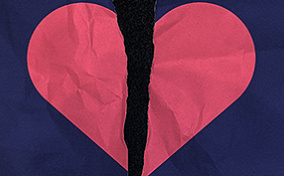 A blue paper with a pink heart is torn in half.